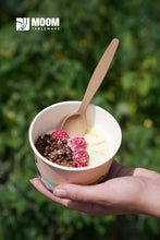 Charger l'image dans la galerie, Reusable biodegradable spoon in hand, serving dessert in a cup with raspberries and granola, outdoors.