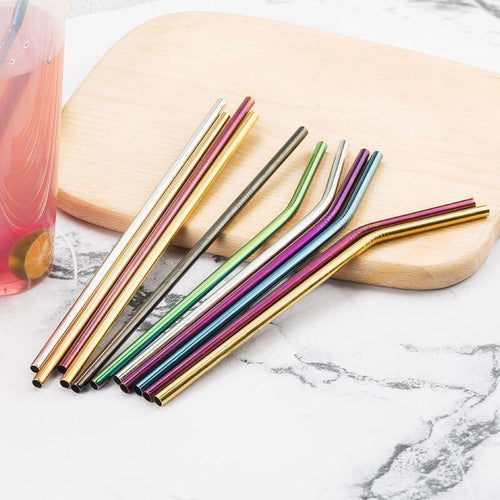 Colorful stainless steel straws on a wooden surface, featuring straight and curved designs, reusable and eco-friendly.
